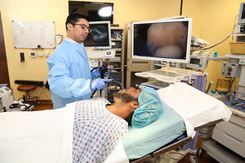 Photo A Doctor Performs A Medical Procedure To A Patient
