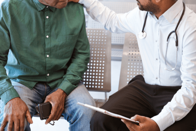A doctor speaking to a patient about what Causes Hernia
